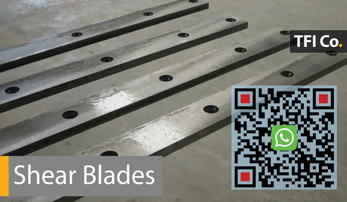 Finished shear blades with countersunk mounting holes and TFI Co. markings, ready for delivery