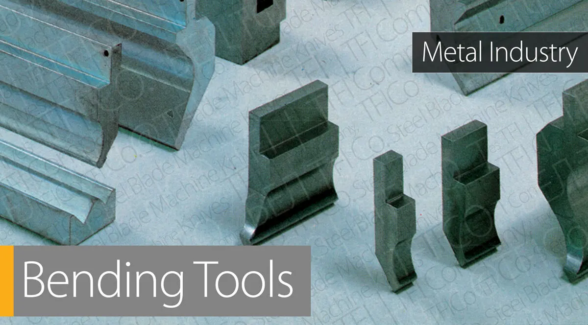 Press brake punches and dies of different profiles standing on a workbench